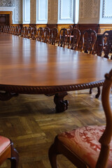 Long classic hardwood table and chairs for official meetings in a palace in Copenhagen.