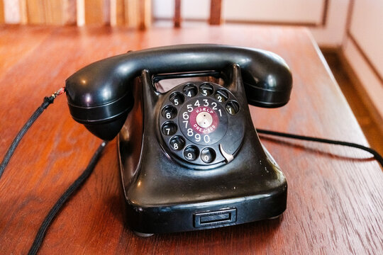 Old wheel and cord telephone, black, vintage.