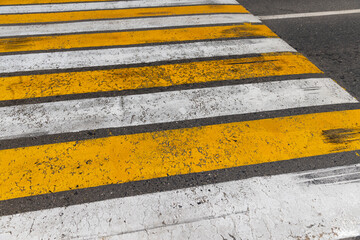 white and yellow pedestrian crossing on the road