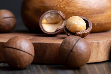 Unpeeled macadamia nuts on a wooden table