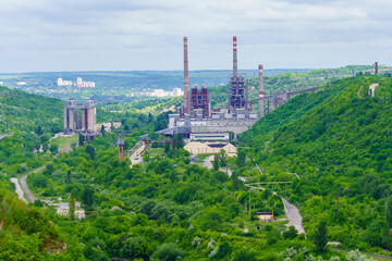 Plant or factory. Industrial area in a picturesque beautiful green area. Background with selective focus and copy space