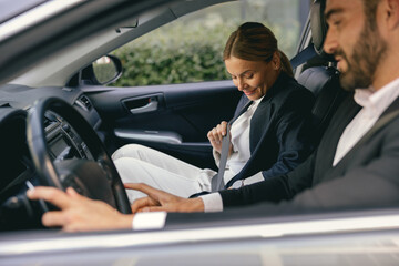 Two positive business colleagues in suit carpooling journey into work together