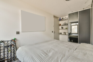a bedroom with a bed, desk and shelves on the wall behind it is an open door that leads to another...