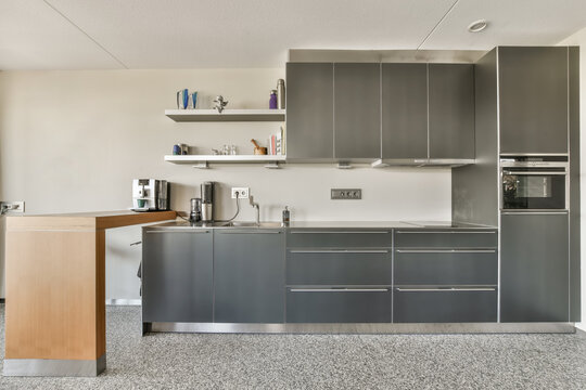 a modern kitchen with gray cabinets and stainless appliances on the counter tops in this photo is taken from the inside