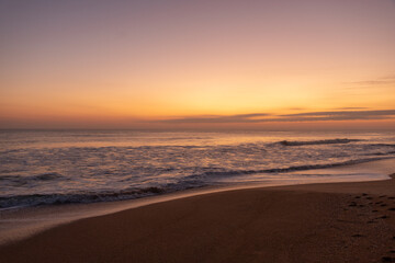 Fototapeta na wymiar Crashing waves at sunrise during golden hour on Florida east coast beach