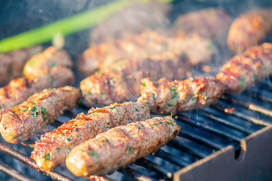 Cutlets Lyula kebab minced meat with spices and herbs are prepared on the grill. Picnic, cooking.