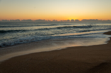 Crashing waves during golden hour at sunrise on Florida beach