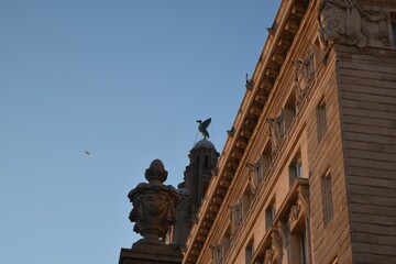Stony building facade under blue bright sky in Liverpool