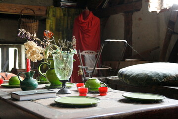 The table is adorned with plates and vases