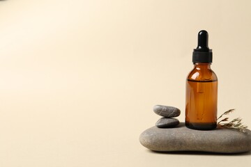 Composition with bottle of cosmetic serum on beige background. Space for text