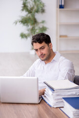 Young male employee working in the office