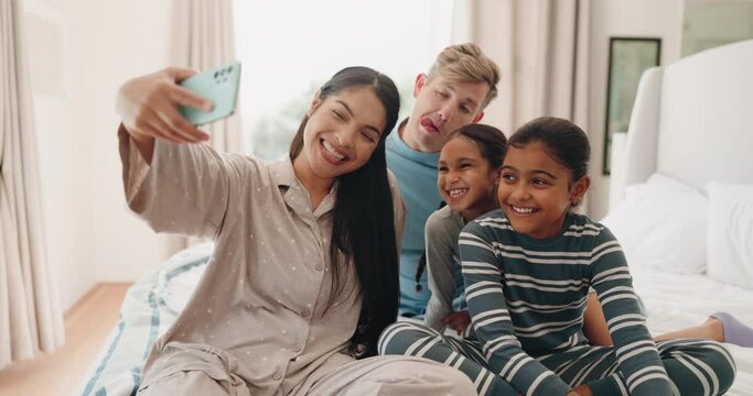 Funny, selfie and family in home bedroom, bonding or laughing together. Profile picture, happy and parents with kids, interracial mother and father smile to take photo for social media after adoption