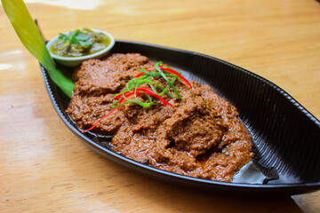 Beef Rendang is a Minang dish originating from the Minangkabau region in West Sumatra, Indonesia. Rendang has been slow cooked and braised in a coconut milk seasoned with a herb and spice mixture