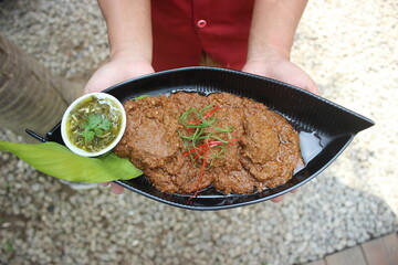 Beef Rendang is a Minang dish originating from the Minangkabau region in West Sumatra, Indonesia. Rendang has been slow cooked and braised in a coconut milk seasoned with a herb and spice mixture