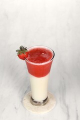 Strawberry juice with ice cream is served in a very luxurious clear glass. isolated in white and dark background