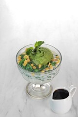 fruit ice with green ice cream topping. isolated in white background