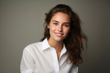 photo of a young woman wearing a white shirt and smiling looking at the camera, one color background, generative ai