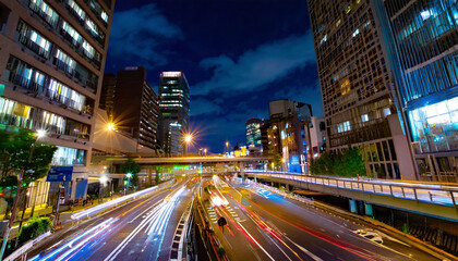 Fototapeta na wymiar A night traffic jam at the city crossing in Tokyo wide shot