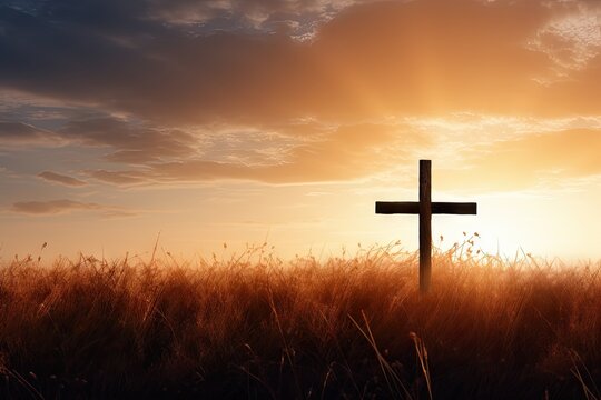 Silhouette of Jesus Christ s cross at sunrise in autumn meadow