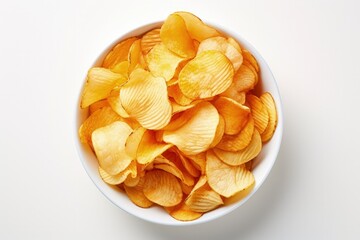 Top view of a bowl of various delicious potato chips on a white surface