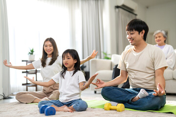 Portrait of love asian fit strength family father and mother with little girl training sitting relax and practicing yoga, fitness, exercise, wellness, workout, sport at home.Diet.Fitness, healthy