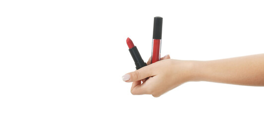 Hand holding lip gloss and lipstick on white background