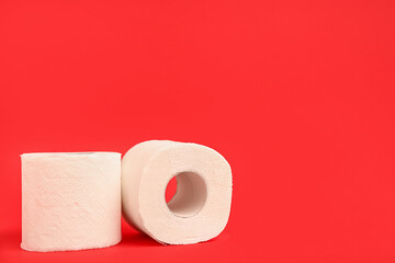 Rolls of toilet paper on red background