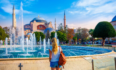 Fototapeta premium Woman looking at Hagia Sophia grand mosque, Istanbul in Turkey