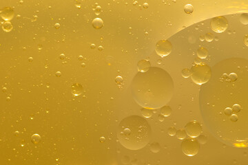 Oil bubble texture on gold background.