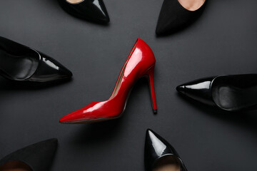 Different stylish high heels on black background