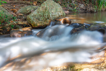 beautiful cascading waterfall over rocks long exposure in Chiangmai Chiang mai mountains northern thailand amongst lush green tropical rainforest