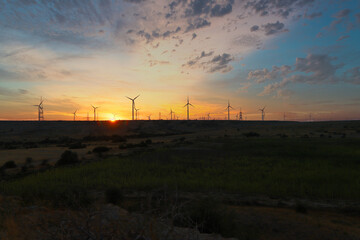 wind turbines with beautiful sunset sky, zorlu energy wind turbines installed in jhampir near gharo sindh Pakistan. renewable energy, green energy