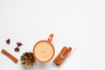 Fototapeta na wymiar Cup of coffee with cinnamon sticks and pine cone on grey background