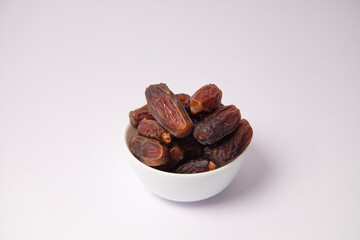 Dates in the white vessel with white background, variety of dates, dates in glass bowl, safawi or Pairom