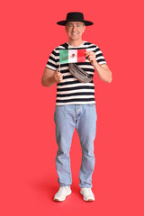 Mature man with Mexican flag on red background