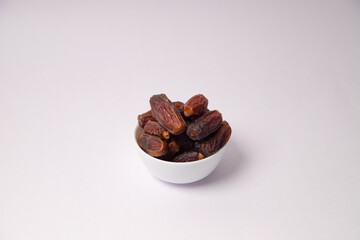 Dates in the white vessel with white background, variety of dates, dates in glass bowl, safawi or Pairom