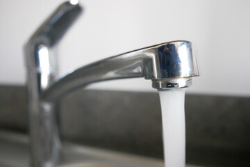 water pouring from a faucet tap slow motion 