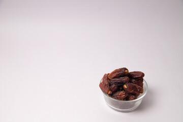 Dates in the white vessel with white background, variety of dates, dates in glass bowl, safawi or Pairom