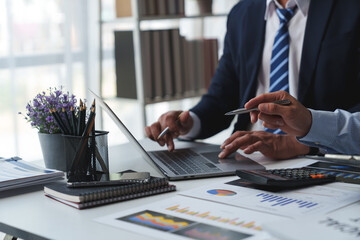 Asian male financial officer or accountant checking investment results Financial budget analysis Planning to summarize results and report to the meeting Audit concept and investment results. - obrazy, fototapety, plakaty