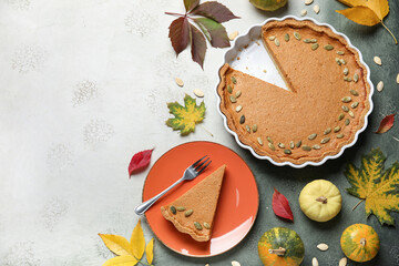 Autumn composition with tasty pumpkin pie on grey background