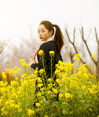 woman in a field of yellow flowers