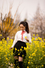 Naklejka na ściany i meble woman in a field of yellow flowers