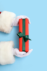 Santa Claus with gift box on blue background