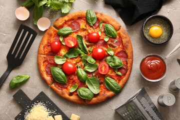 Delicious Pepperoni pizza with tomatoes and basil on grey background