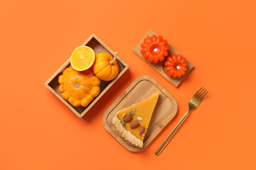 Wooden board with piece of delicious pumpkin tart and burning candles on orange background