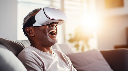 Portrait of an elderly man enjoying playing computer games with virtual reality glasses. Active age concept