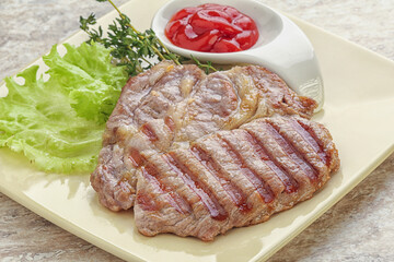 Grilled pork neck steak with ketchup