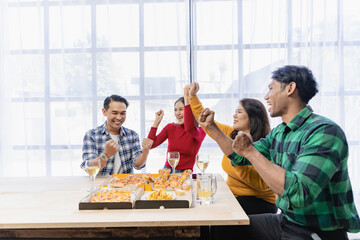 Group of happy Asian young people with friends celebrate clinking glasses during party, food,...