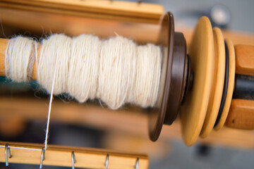 The spinning equipment includes a wooden spindle and a hand tool for sewing.
