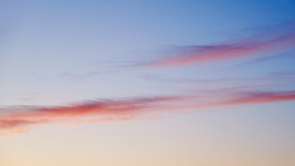 The pink and blue hues of the evening sky were reflected in the clouds, creating a dreamy and romantic atmosphere.